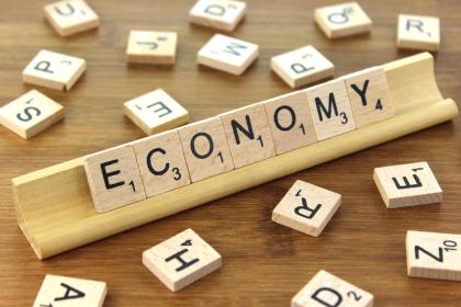 the word 'economy' spelled on a scrabble board