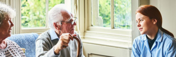 Man and lady talking to care worker