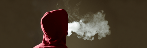 Decorative - Person in hooded top using an e-cigarette/vape