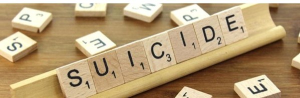 Wooden scrabble letters spelling the word suicide