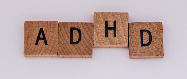 Wooden tiles with the letters ADHD written on them.