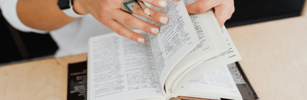 A person flicking through a dictionary