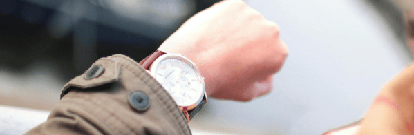 A person checking the time on their watch